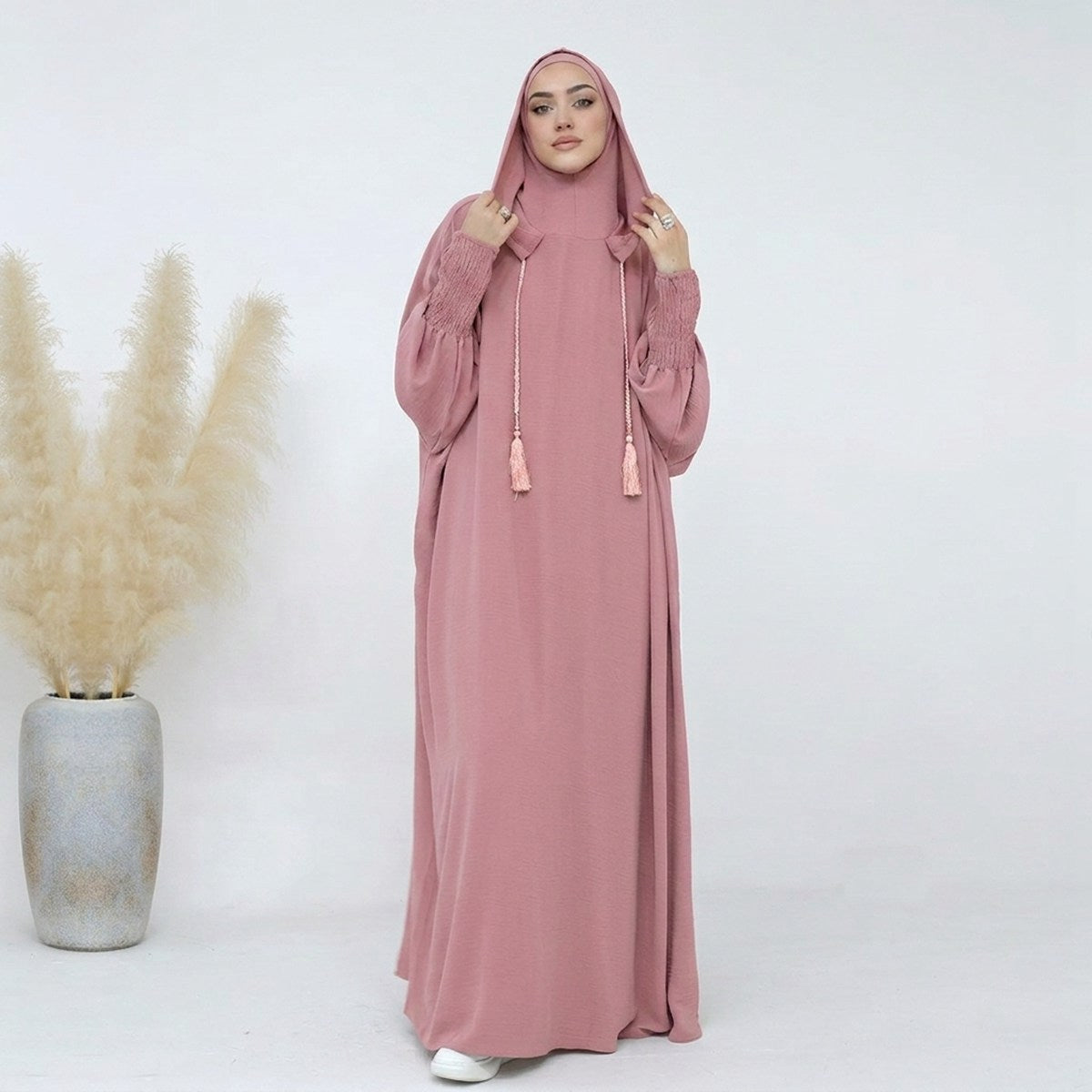 Pink hooded prayer dress, full-length front view, soft fabric with tassel tie detail